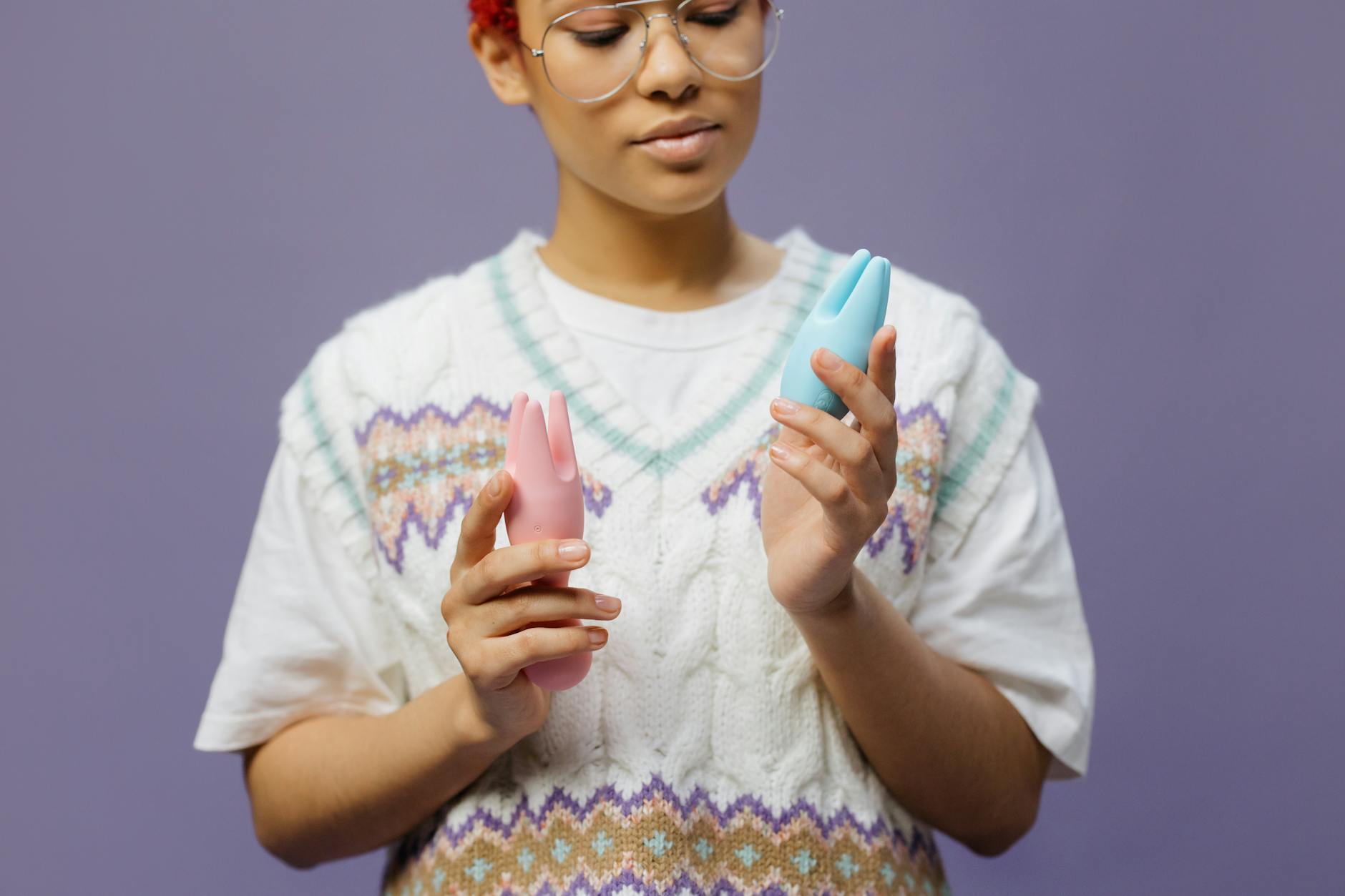 Woman holding contemplative expression while discovering new sensations with vibrator