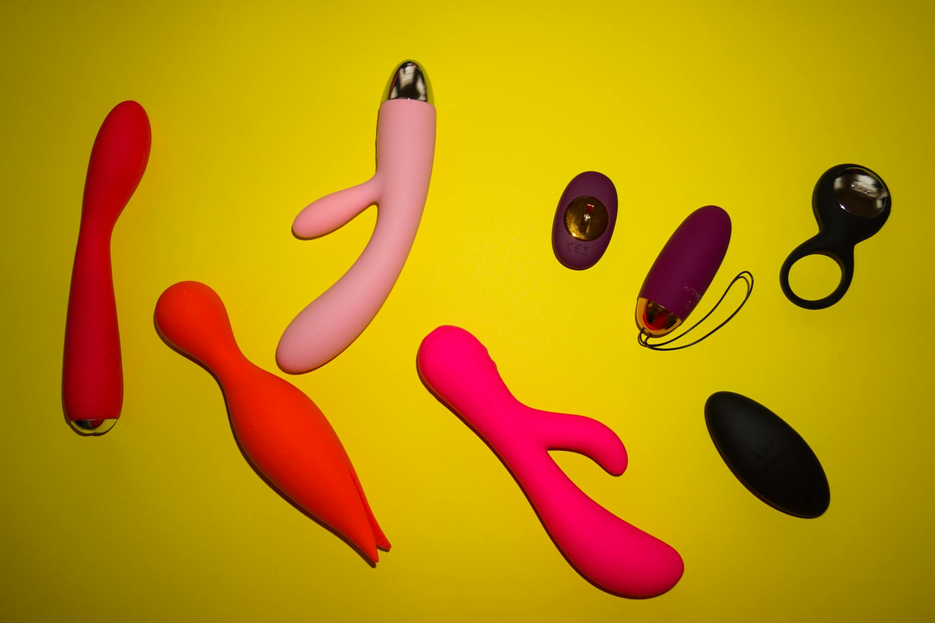Woman holding and exploring a modern clitoral vibrator with intention and confidence